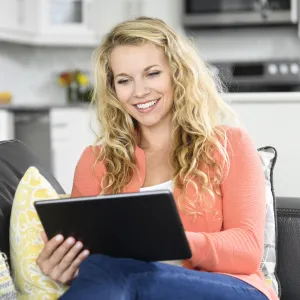 A woman reading on her tablet. 