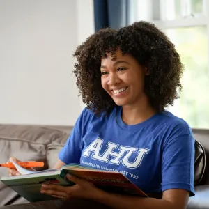 a woman wearing an AHU shirt