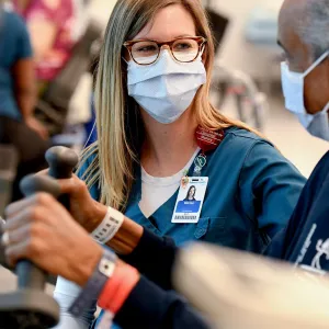 A nurse works with an older patient.