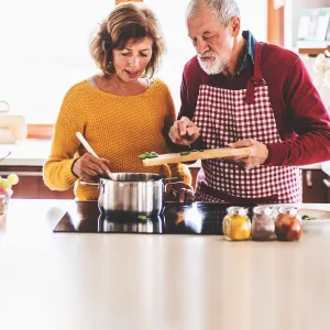 A mature couple cooking dinner.