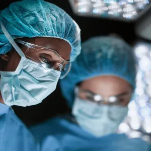 Plastic Surgeons performing an operation.
