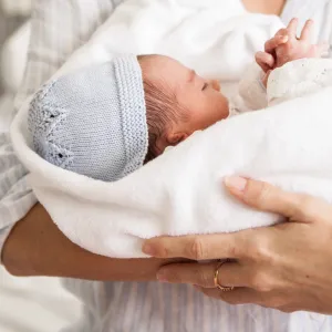 baby in adult's arms