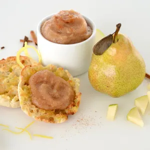 dish and muffin with pear and date sauce next to a whole pear and pear pieces