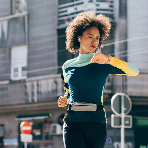 Young black woman running outside