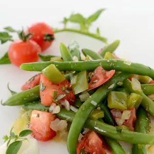 Vegetable dishing including green beans, tomatoes, and peppers