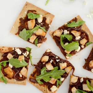 Six squares of chicken flatbread on white counter