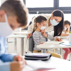 Teacher in classroom with students wearing masks