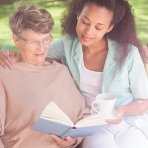 Two women reading a book together