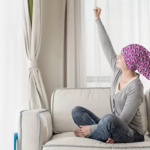 Cancer survivor stretching arm upwards