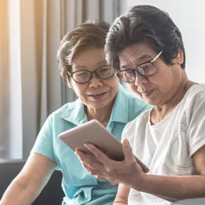 two women reading tablet