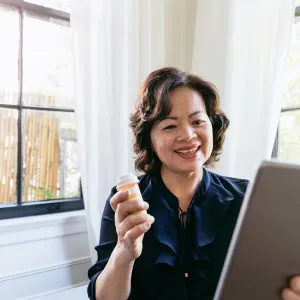 Woman showing her doctor her medication on a tablet.