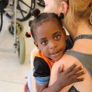 a child hugs a woman