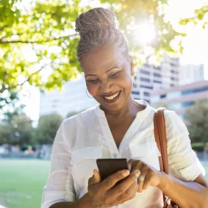 Woman using her phone while at a park.