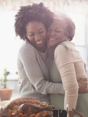 Mother and duaghter embracing in the kitchen filled with happiness