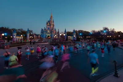 Runners running runDisney event at Magic Kingdom in front of Cinderella's Castle.