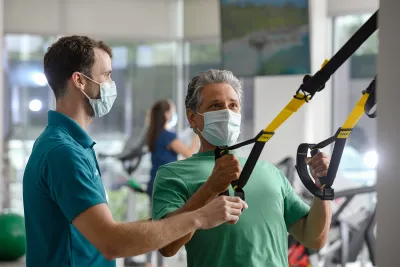 Man with trainer at the AdventHealth Health Park gym.