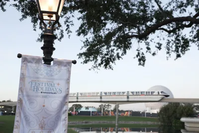 Epcot International Festival of the Holidays banner with monorail and Spaceship Earth in the background.