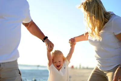 A couple with their child at the beach.