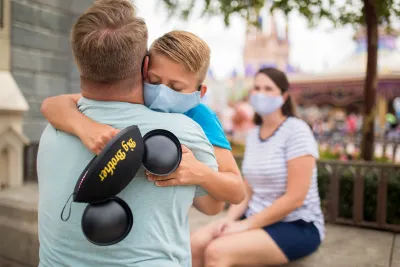 Son hugging dad after Dad telling him he is going to be a big brother.