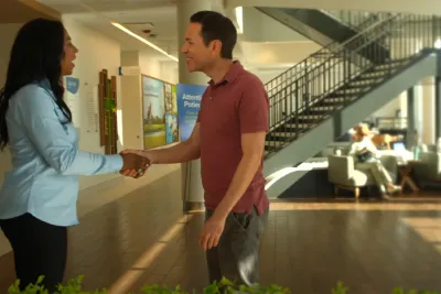 A patient shakes hands with an AdventHealth employee at a Health park facility.