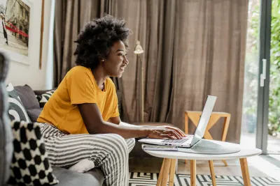 A woman on her laptop at her house