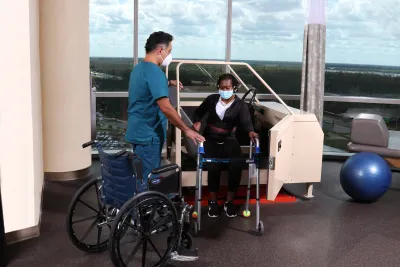A Physical Therapist Helps a Patient During a Session.