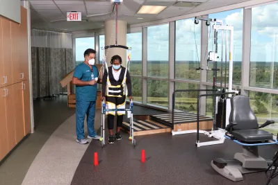 A Physical Therapist Helps a Patient During a Session.