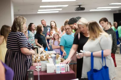 People waiting for a table booth at the Maternity Fair