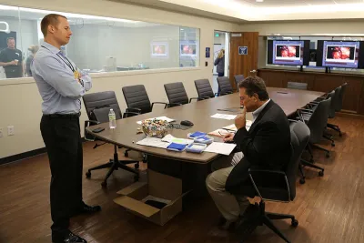 Two people working in a Nicholson Center Lab Boardroom.