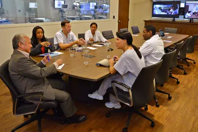 Professionals in a meeting in a Nicholson Center Lab Boardroom.