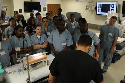 Surgeons watching a spinal surgery demonstration.