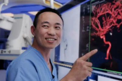 A nurse pointing his finger on the medical screen