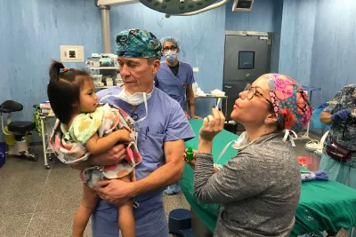 a child being held by a doctor