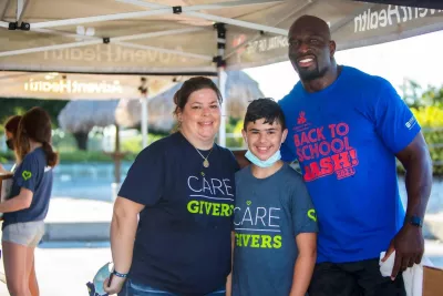 Three volunteers pose for a photo