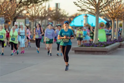 Woman running runDisney Princess 10k runner at Epcot.