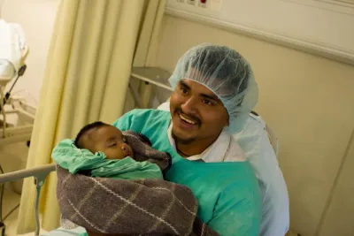 A man holds a baby