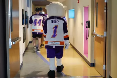 Solar Bears and Shades walking through hospital hallway.