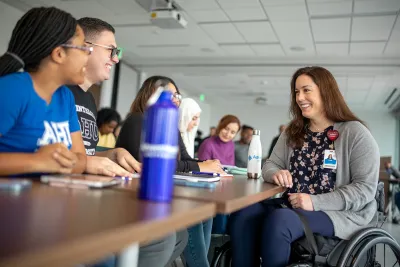 An AdventHealth University teacher talking with students.