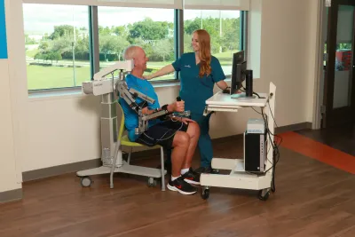 A Physical Therapist Helps a Patient During a Session.
