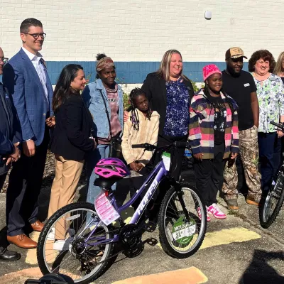 AdventHealth and Volusia County Schools leaders present free bikes to first of nearly 170 students.