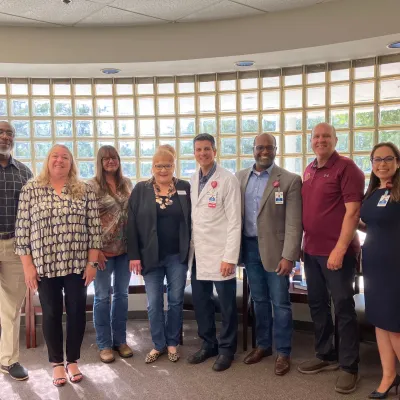 Clinic patients and cancer survivors, Teresa Ledford and Rena Weldon visits with AdventHealth physicians, leaders and State Representative Truenow.  