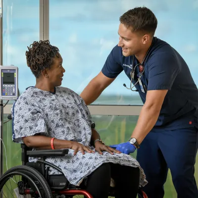 A female patient in a wheelchair with her provider.