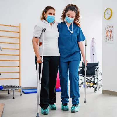 A Physical Therapist Helps a Patient During a Session.