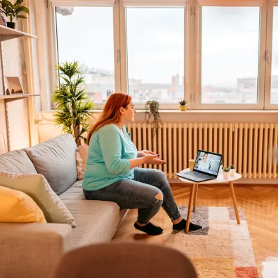 A Patient Speaks to Her Doctor Via Laptop During a Telehealth Visit