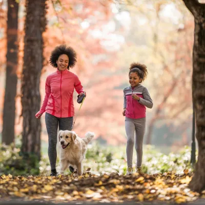A Mother and Daughter Go For a Jog in a Wooded Park