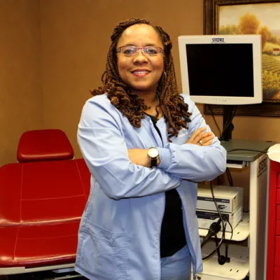 A woman standing in the middle of a consultory.