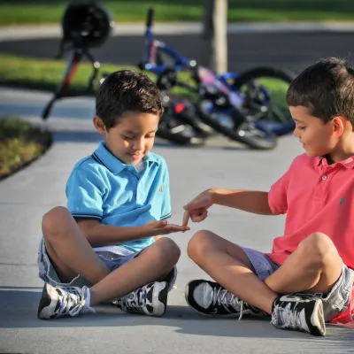 Kids Playing on Sidewalk with Bikes