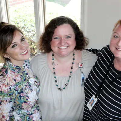 Three women hugging each other