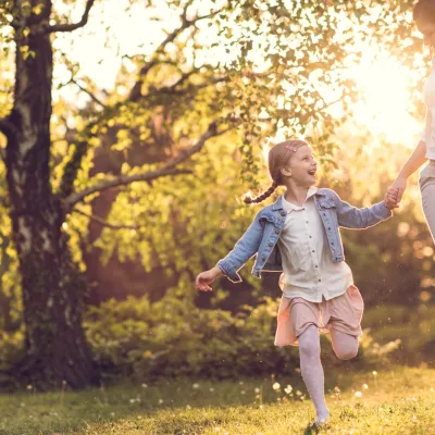 Mother and daughter skipping.