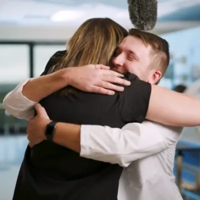 AdventHealth nurse Delaney Postma and UCF student Maxwell Jones hug, after seeing each other for the first time since Jones was accepted into the College of Nursing.